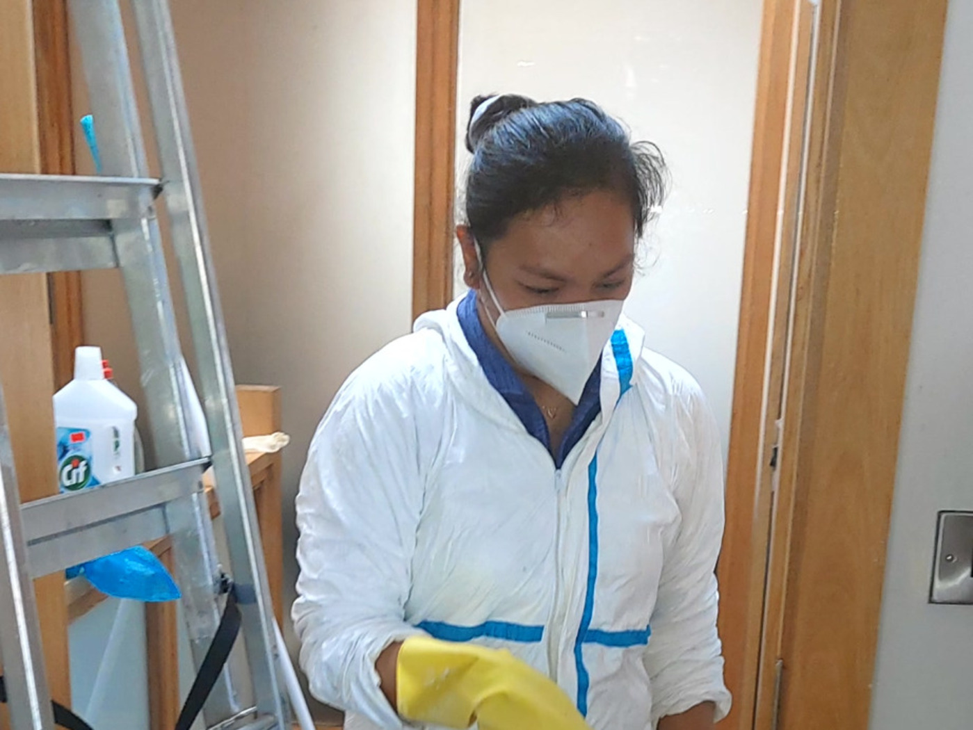 Phoenix husband-and-wife extreme cleaning team member wearing protective equipment during a real property job in Ireland