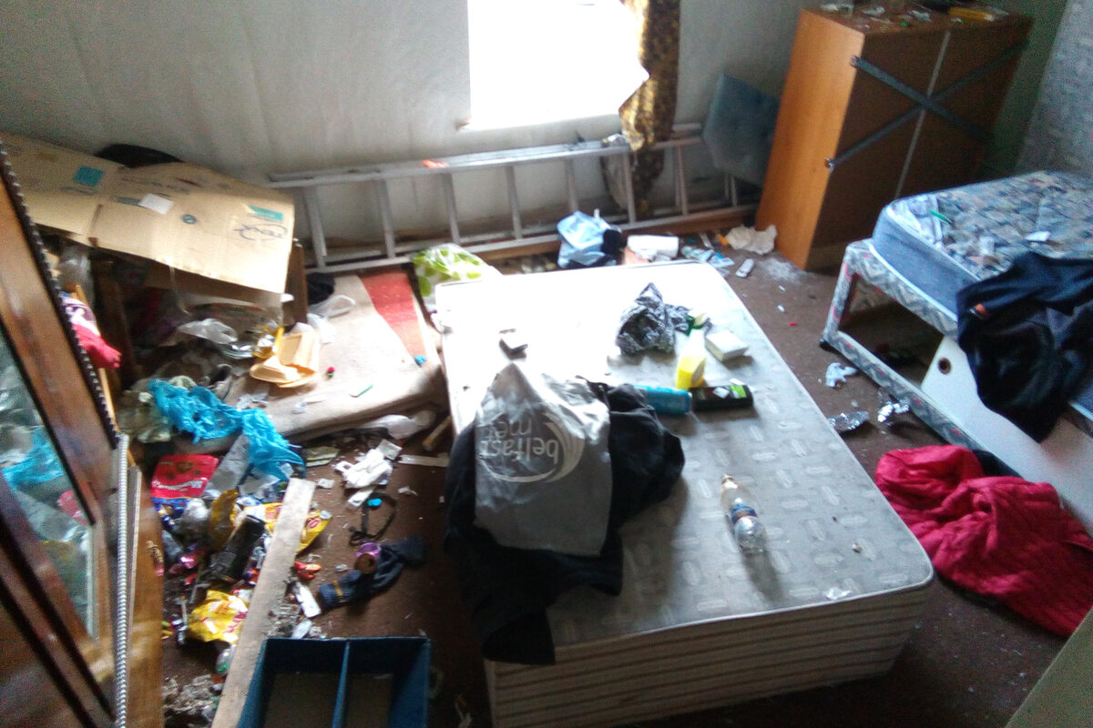 Severely cluttered bedroom requiring extreme clearance and deep cleaning