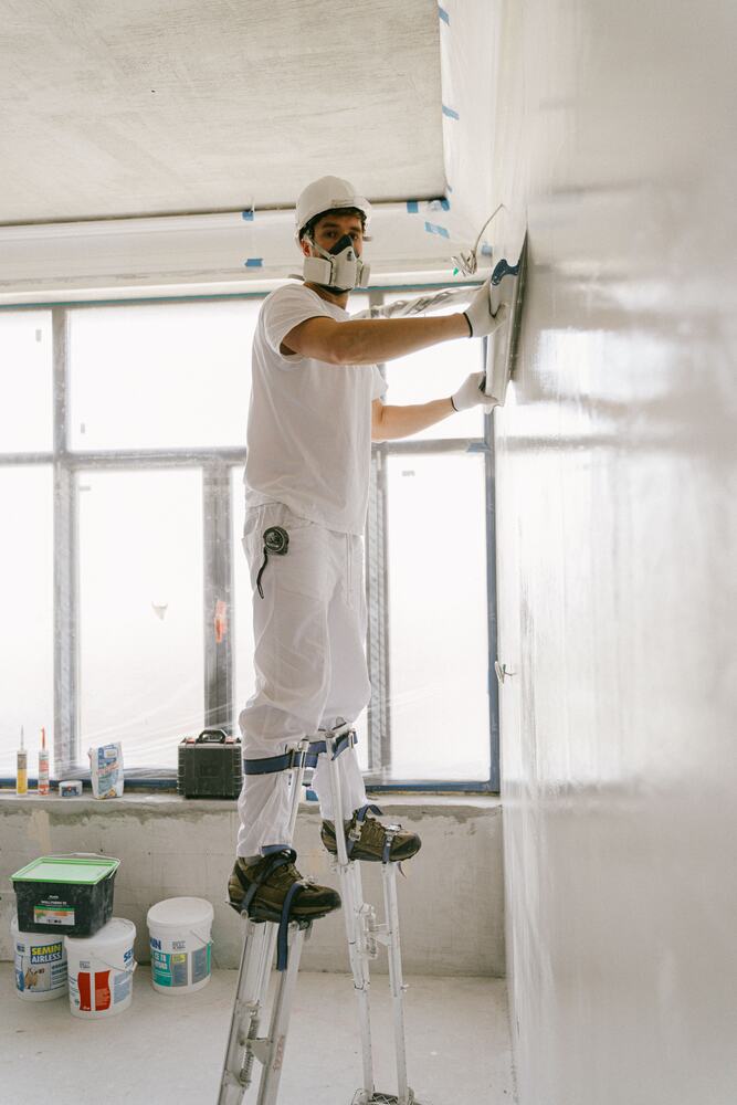 Worker wearing respiratory protection during property preparation work